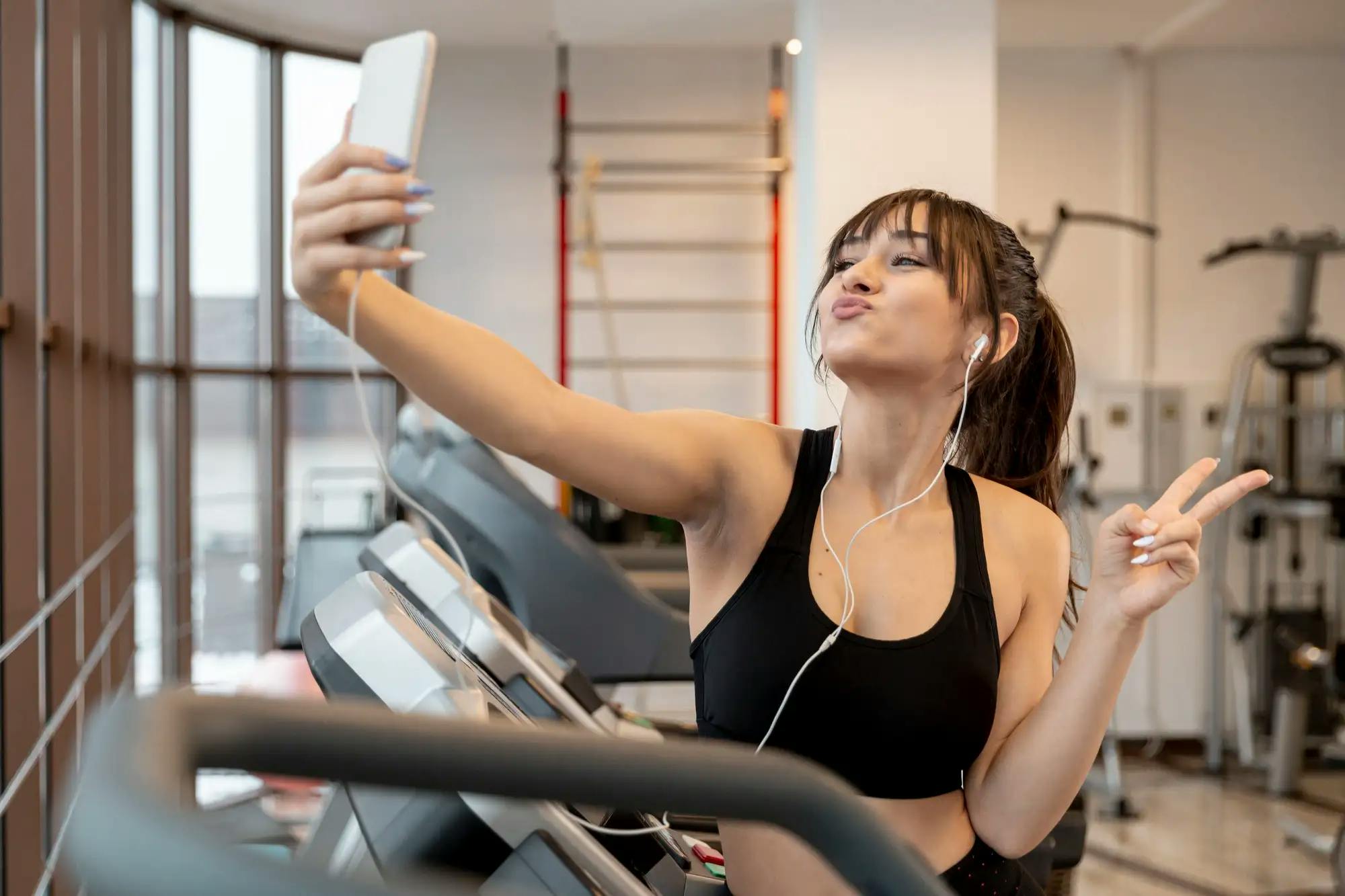 woman at gym taking selfies